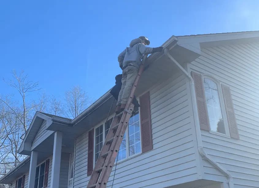 Gutter cleaning and maintenance being performed by Akron Power Washing in Akron